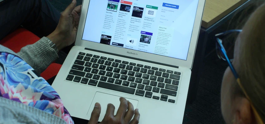 Teachers looking at Topic Explorer — one of the many tools offered by Services to Schools — on a laptop