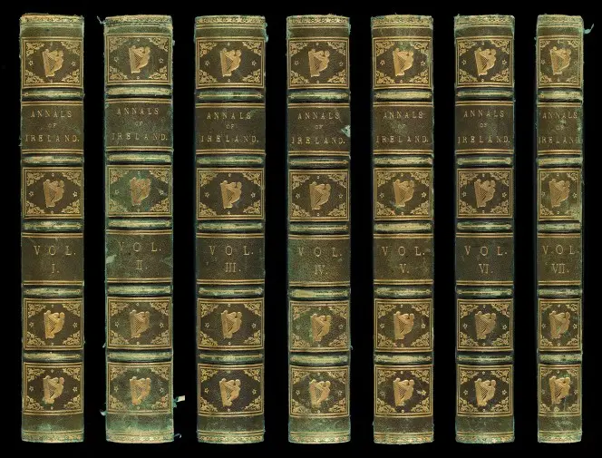 Spines of the seven volumes of Annals of Ireland, illustrated with Celtic harps.