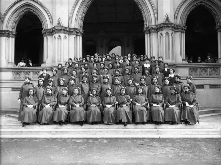 Group portrait of the first nurses to leave for World War I. The steps of the General Assembly Library, Wellington, New Zealand. The Press (Newspaper): Negatives.