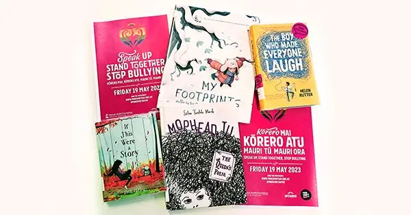 Books about bullying laid out beside posters promoting Pink Shirt Day on 19 May 2023.