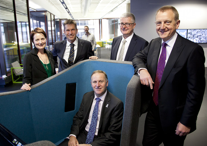 Prime Minister John Key sitting in an AV pod.