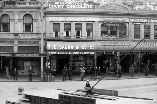 This GIF compares detail from an older scan of a 120 copy negative with a more recent scan of the original negative. Detail of Custom House Square, Dunedin, taken between 1923 and 1928.