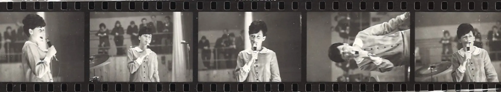Photo negatives of a woman singing. 