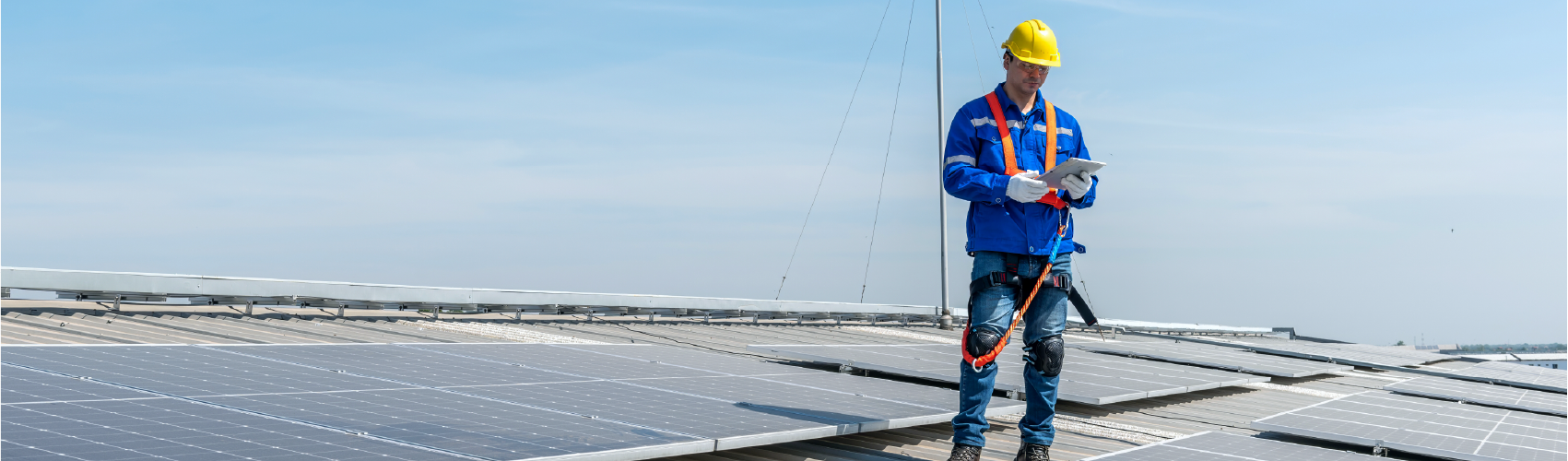 A technician standing on a solar panel array.