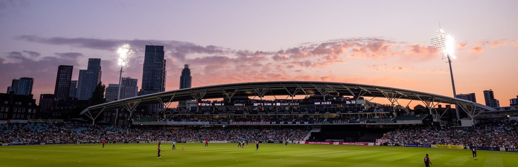 A sunset offering a picturesque backdrop to a stand at the Kia Oval