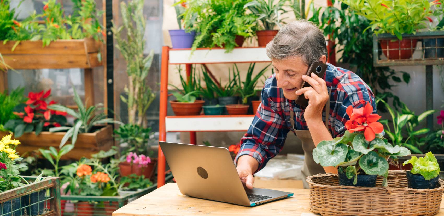 Shop keeper in a garden centre on phone