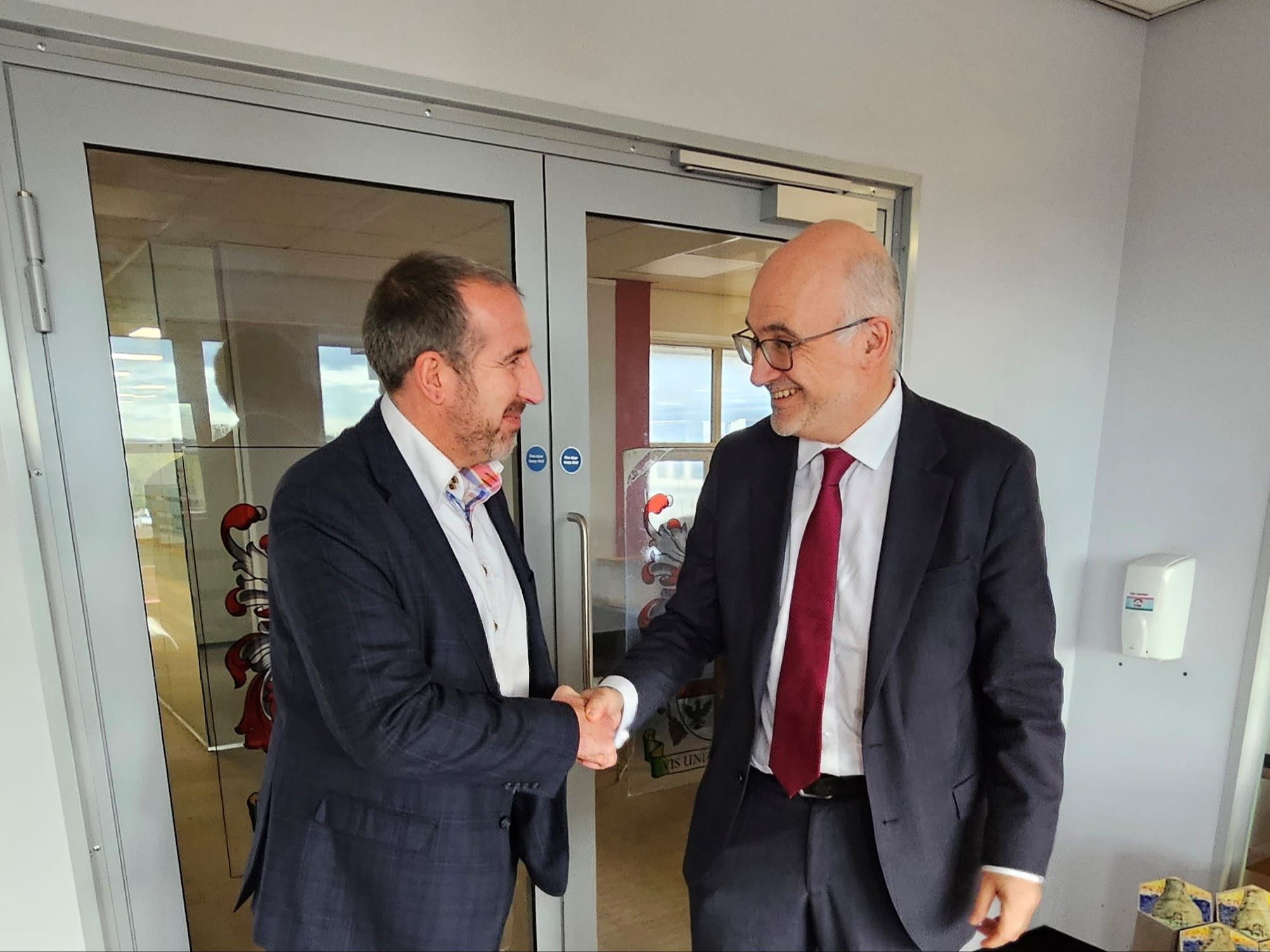 Image of Nathan Sanders, MD SSE Energy Solutions and Jon Rouse CBE shaking hands