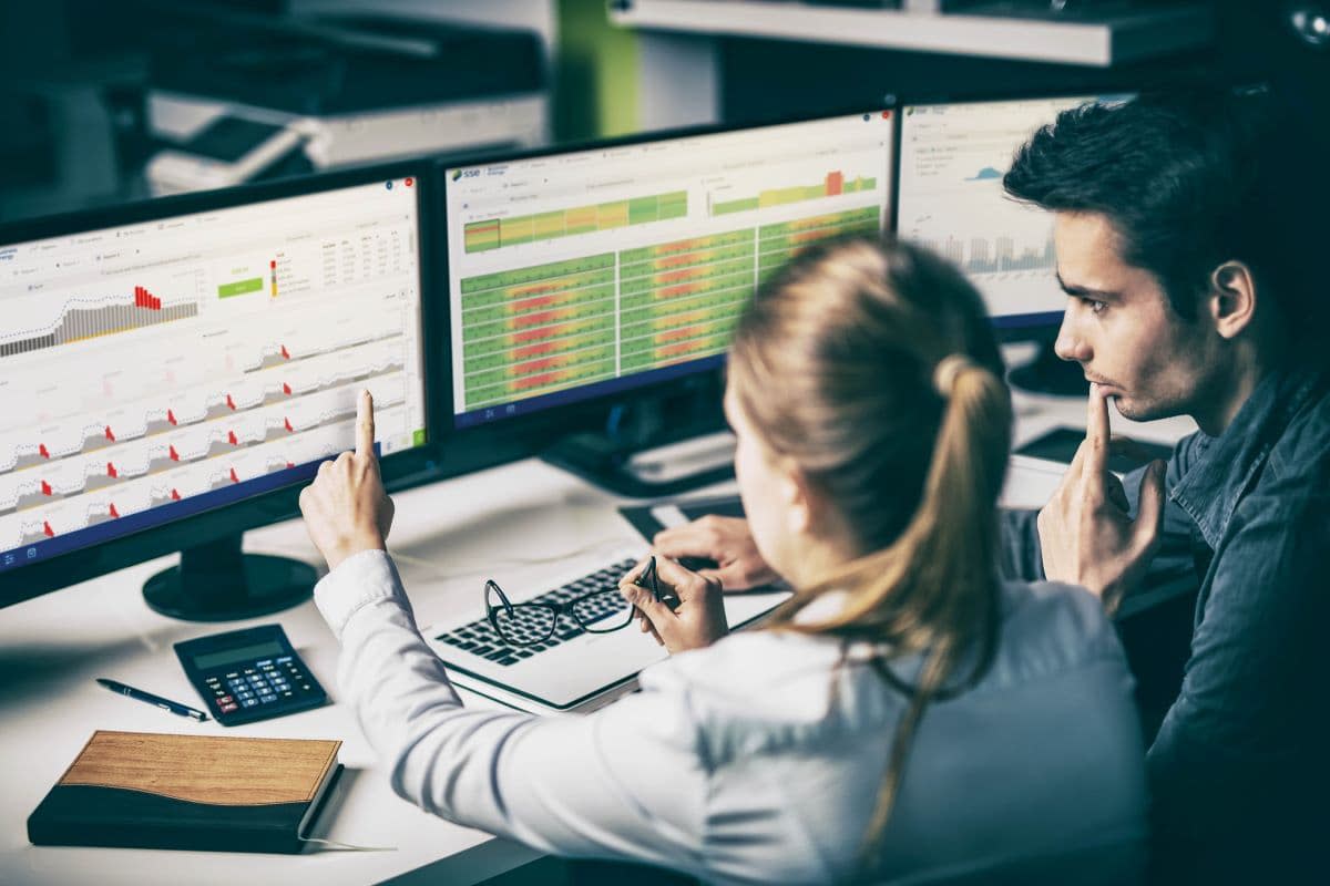 People examining data on computer monitor