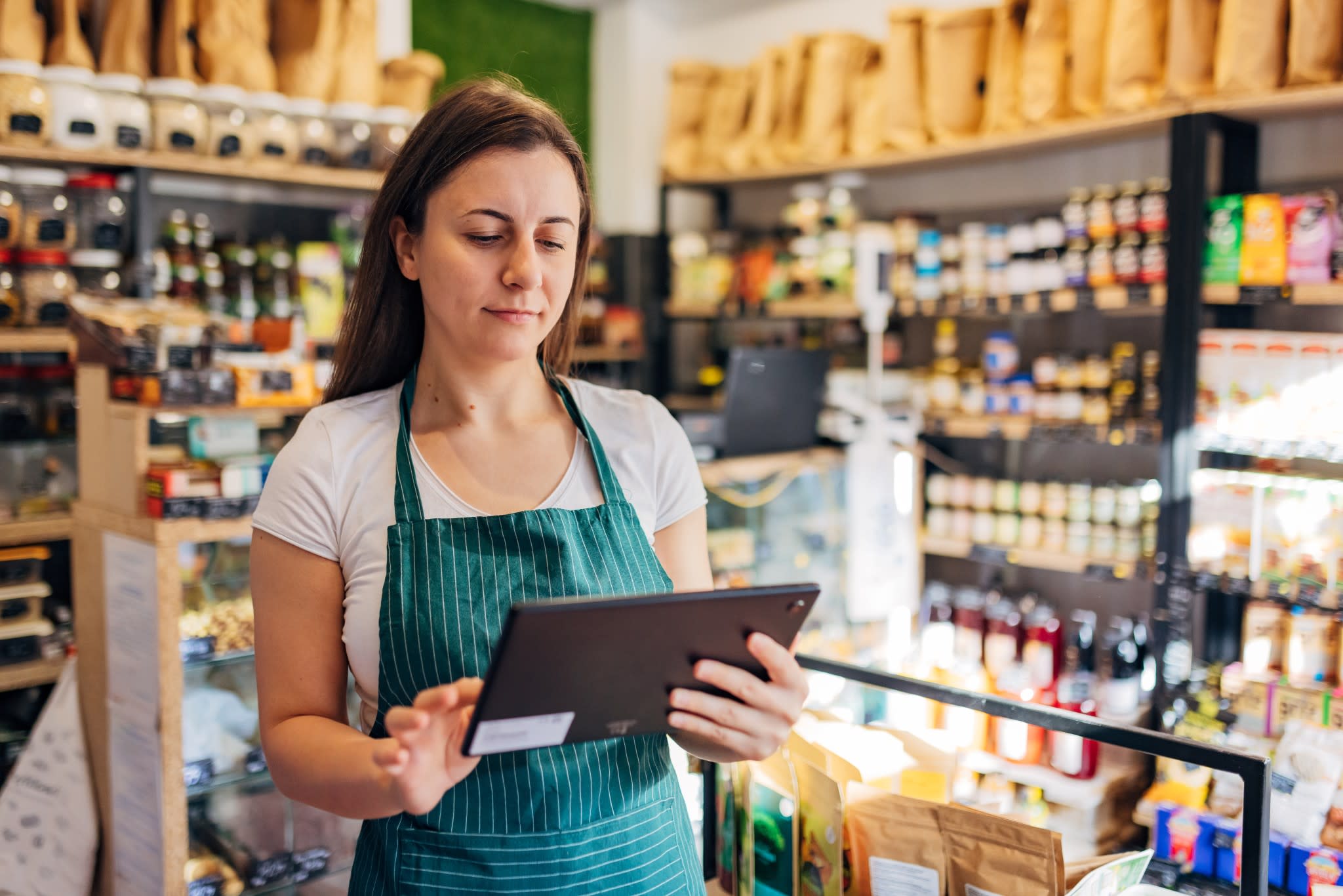 Shop owner looking at tablet