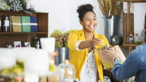 Shop worker serving customer