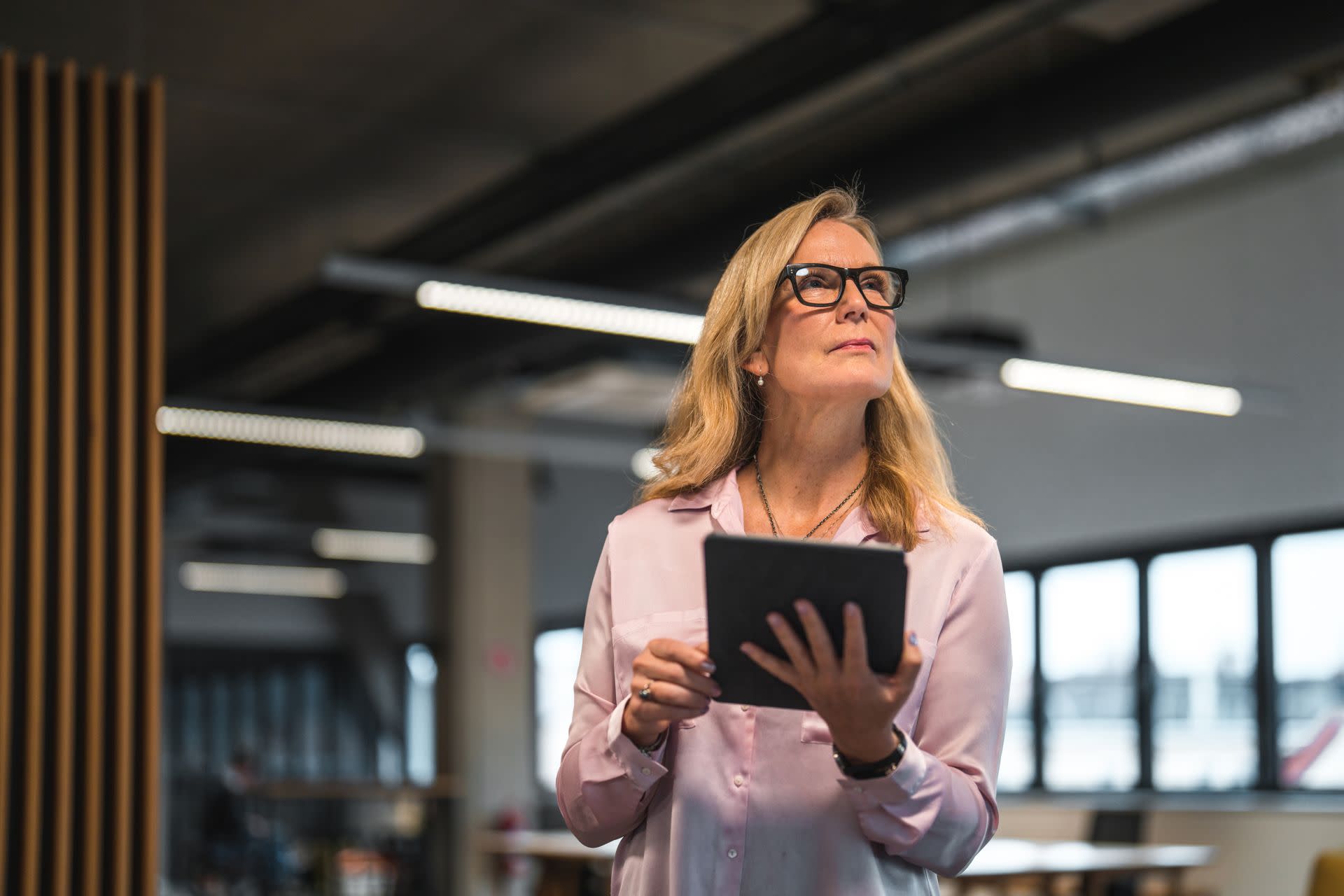Lady in an office setting looking at tablet