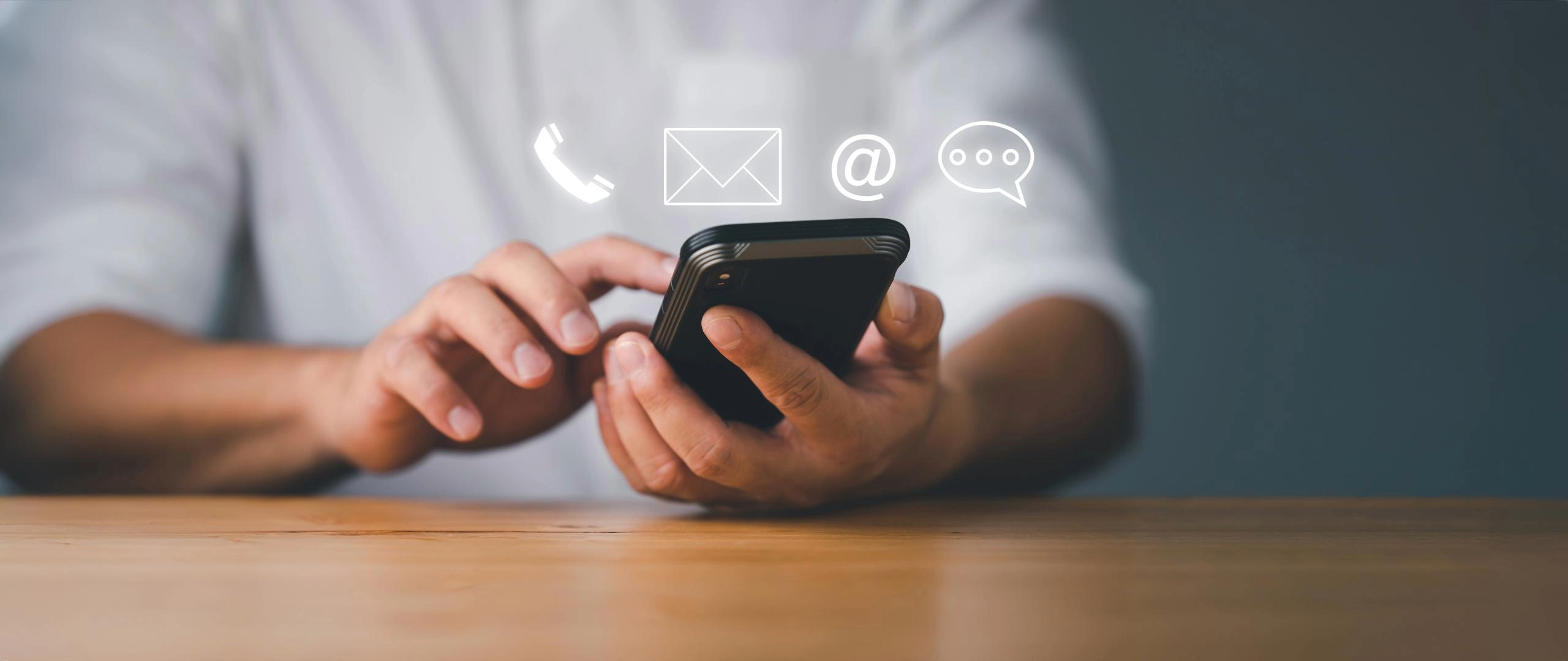 Person using mobile phone at desk