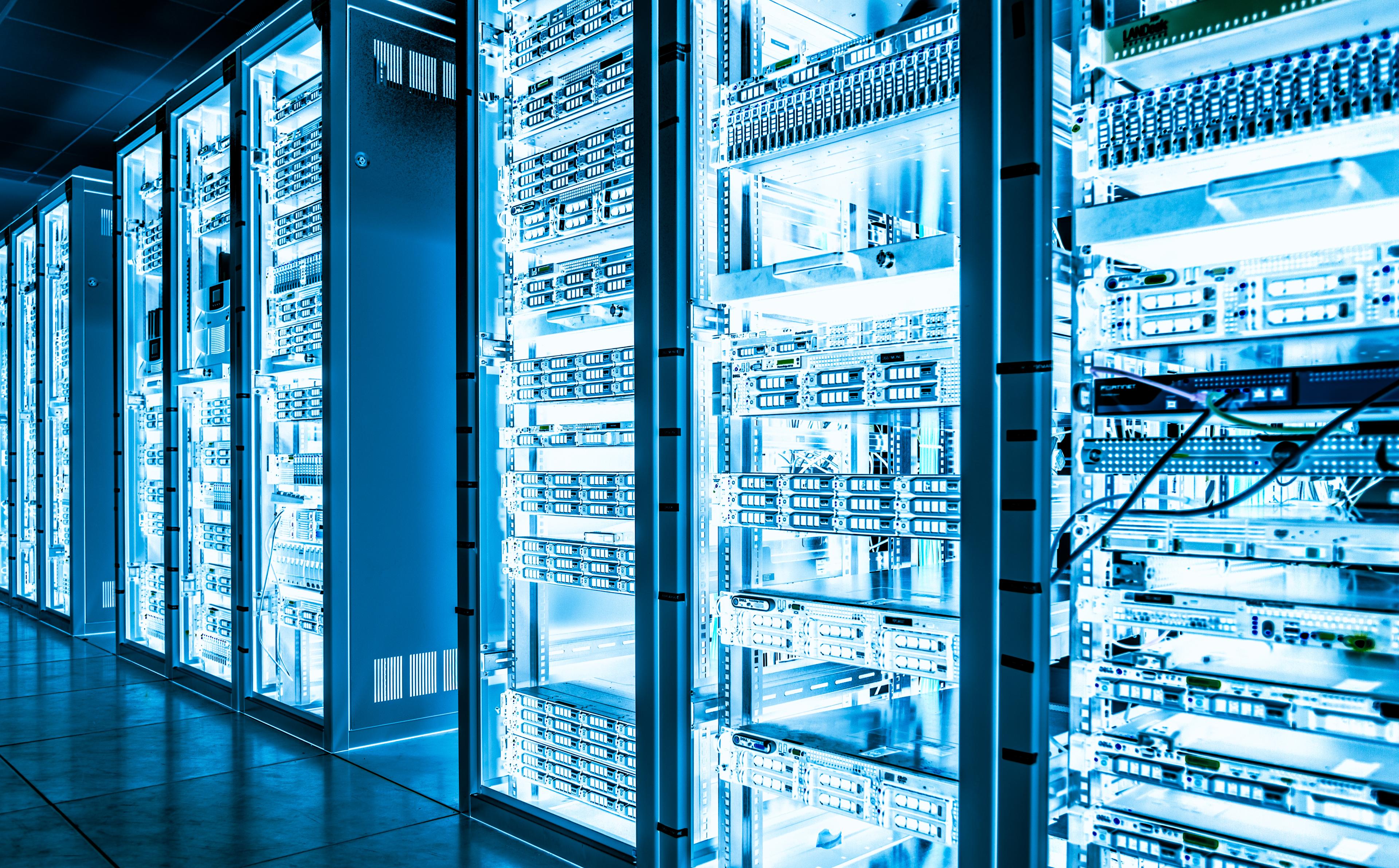 A close up image of data centre equipment, glowing blue with energy.