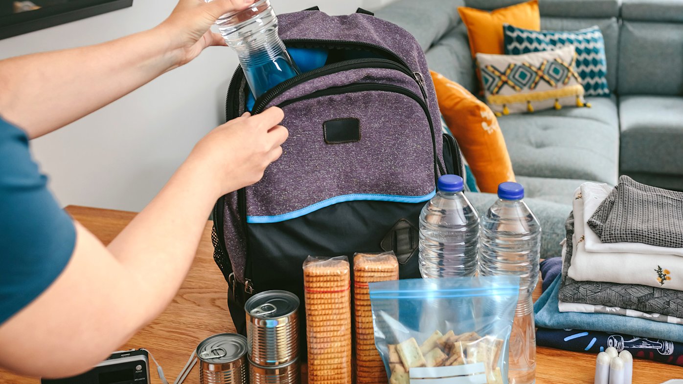 Person filling an emergency preparedness backpack