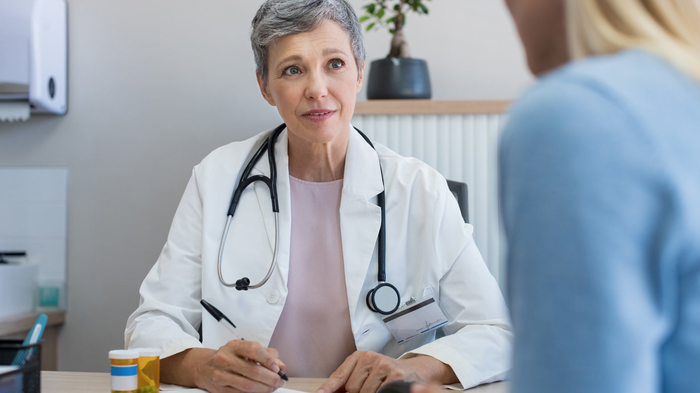 Doctor wearing stethoscope talking to patient