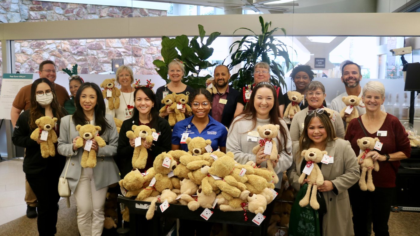 The San Diego Blood Bank, Grossmont Healthcare District and Sharp Grossmont Hospital staff posing with the bears they’re gifting to patients for the holidays.