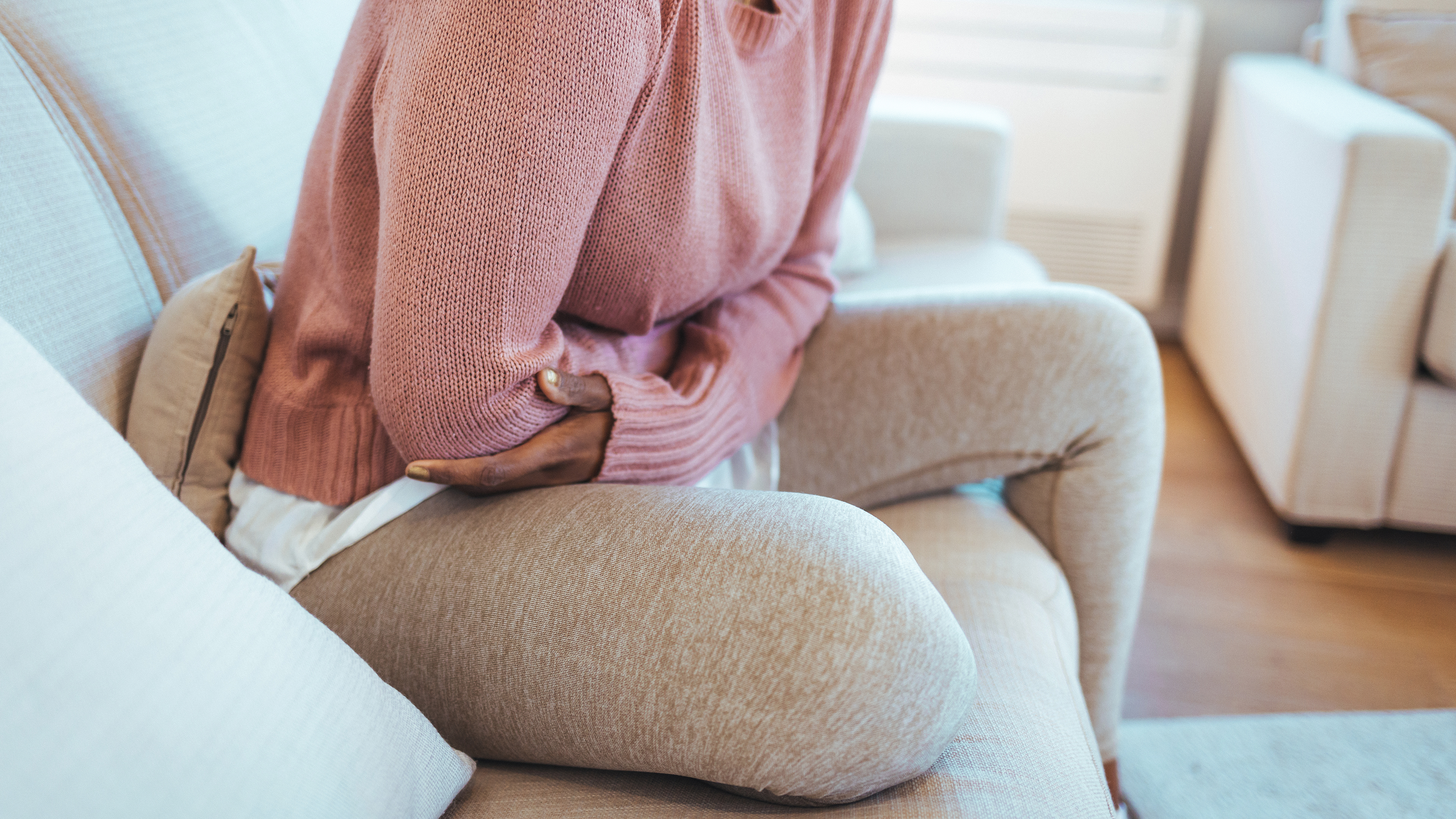 Woman holding her stomach in pain