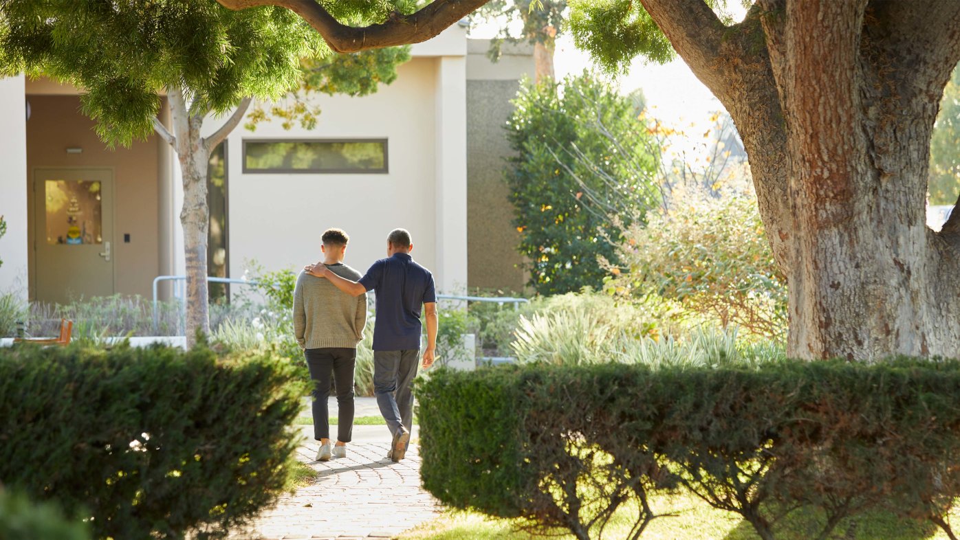 Father and son walking through a Sharp HealthCare campus