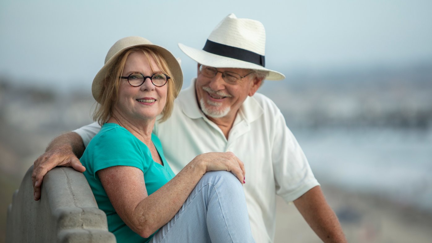 Senior couple on bench overlooking La Jolla shores.
