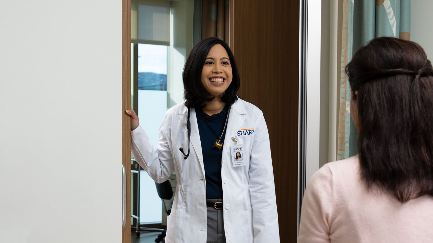 Dr. Var, smiling, entering patient's room.