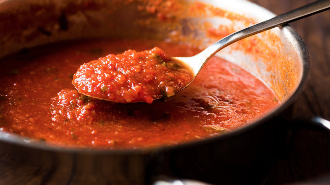 Pasta sauce in a spoon and pot