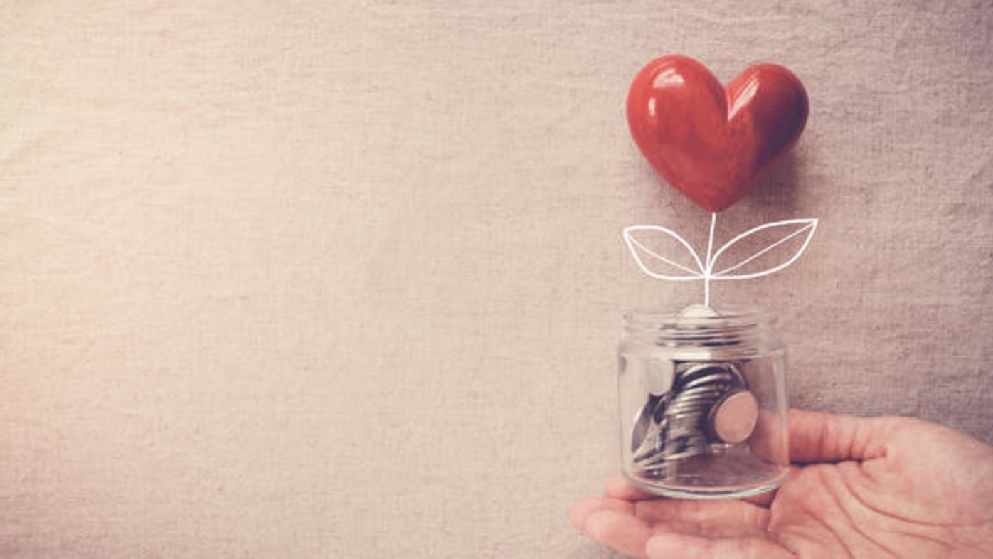 Jar filled with coins with heart flower drawn in