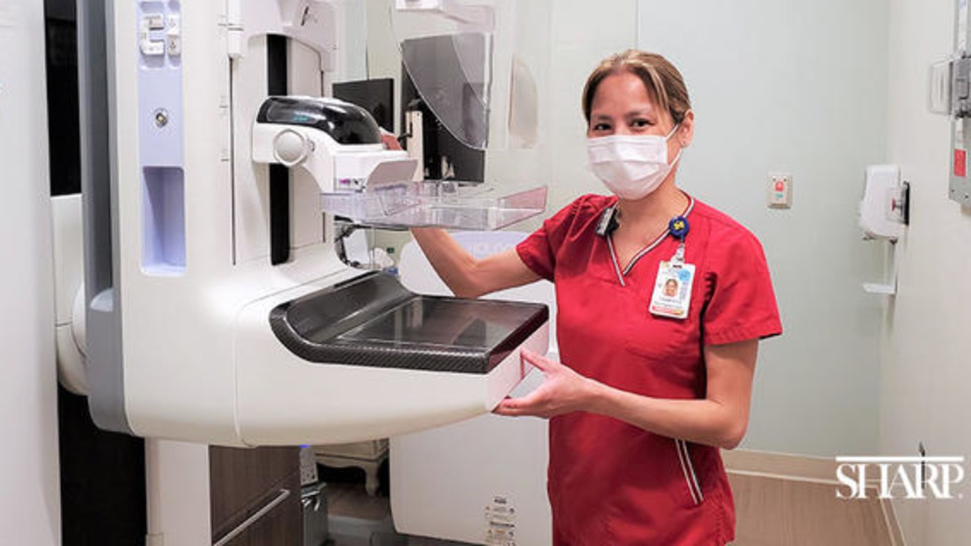 Sharp Rees-Stealy nurse standing next to a 3D mammogram unit.