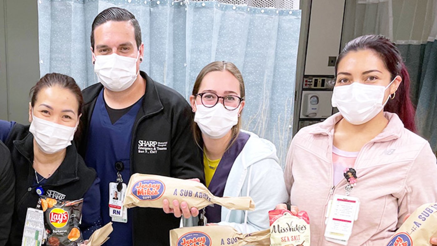 Sharp Memorial Hospital staff pose with donated Jersey Mike’s sandwiches during their shift.