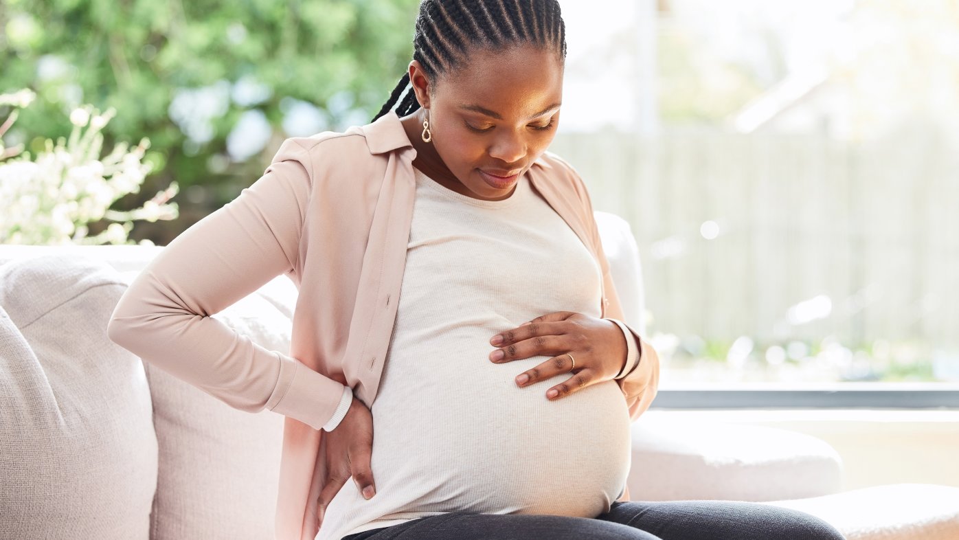 Woman holding pregnant belly