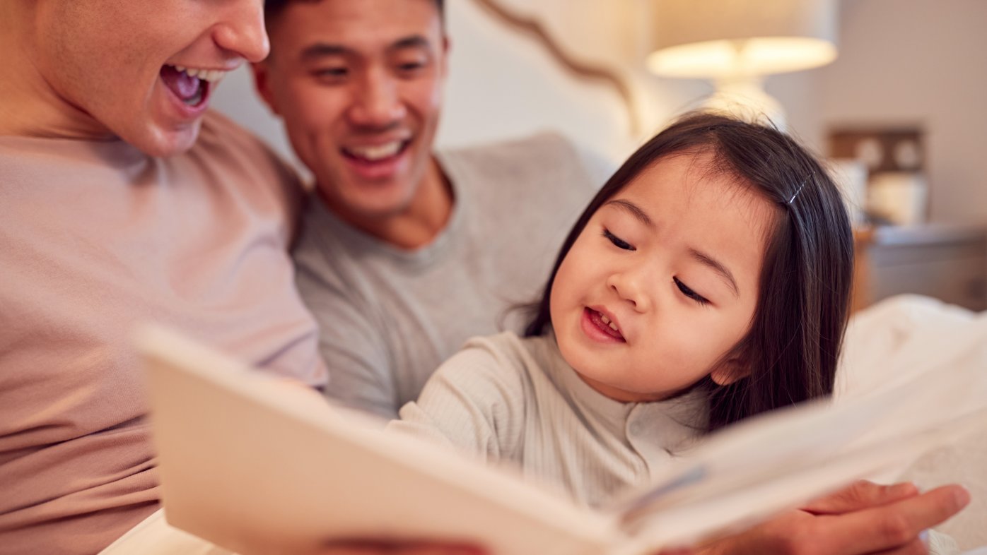 Parents reading to their young child