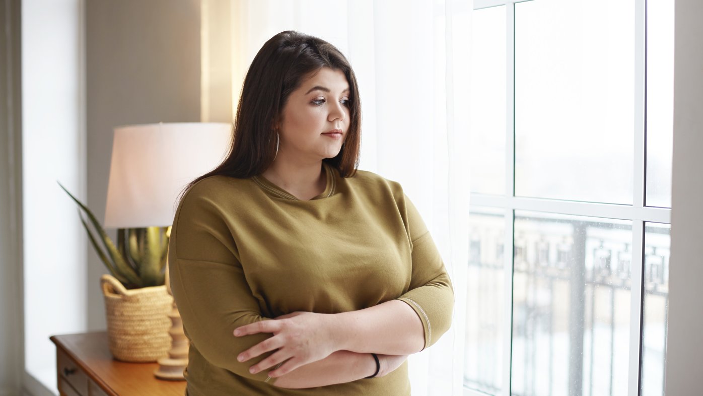 Sad woman looking out a window