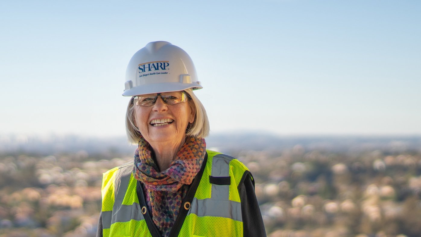 Helga Leonhardt, Sharp HealthCare Foundation donor, wears a hard hat and safety vest while touring new hospital construction at Sharp Chula Vista Medical Center.