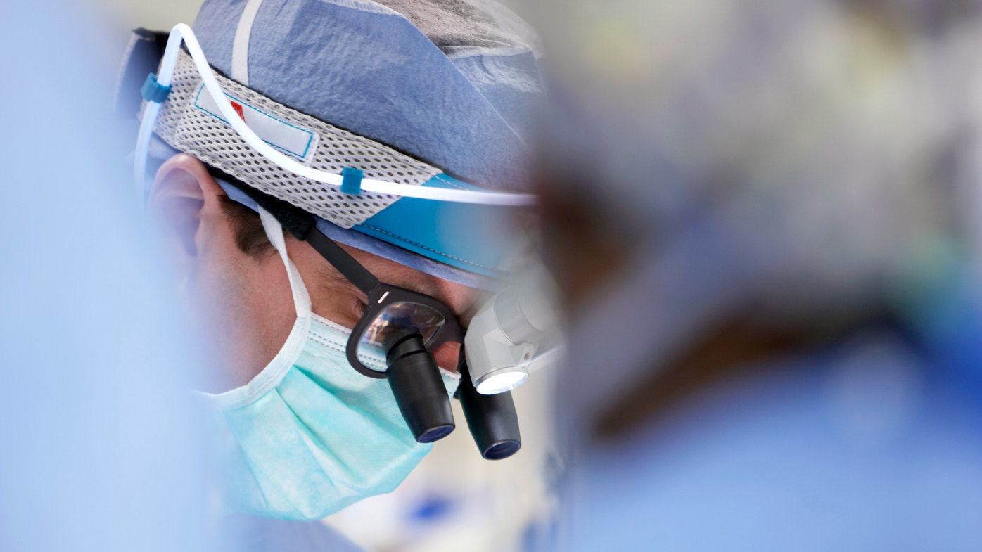 Close up of surgeon wearing medical loupes during surgical procedure.