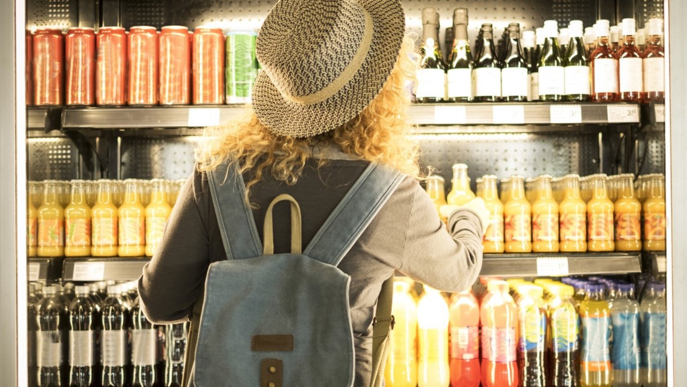 Woman choosing a bottled drink in a store