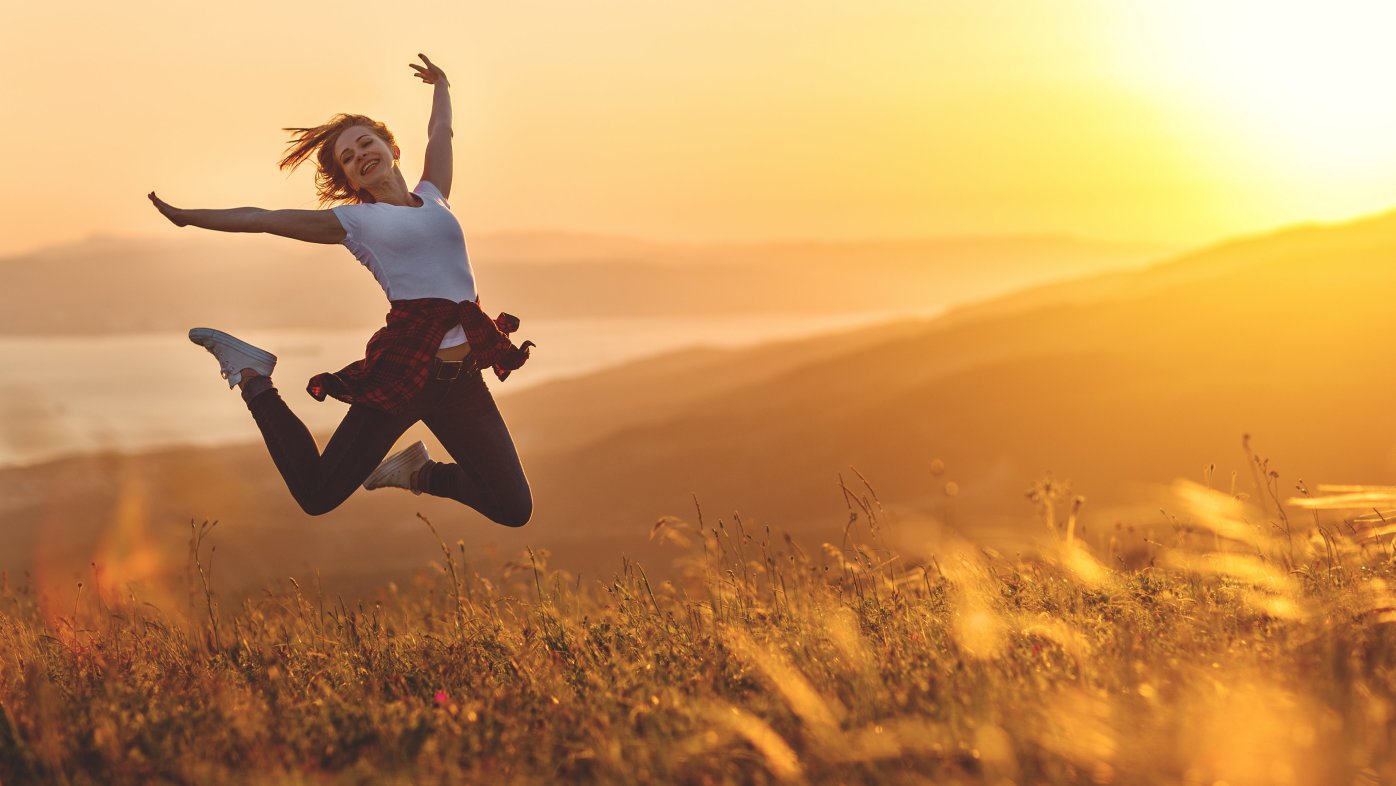 Woman outdoors jumping in happiness