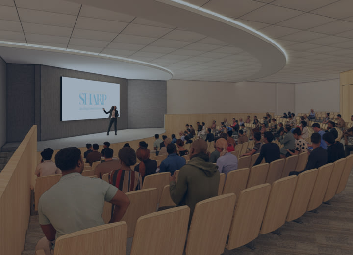 Artist rendering of auditorium with audience seated and presenter on stage