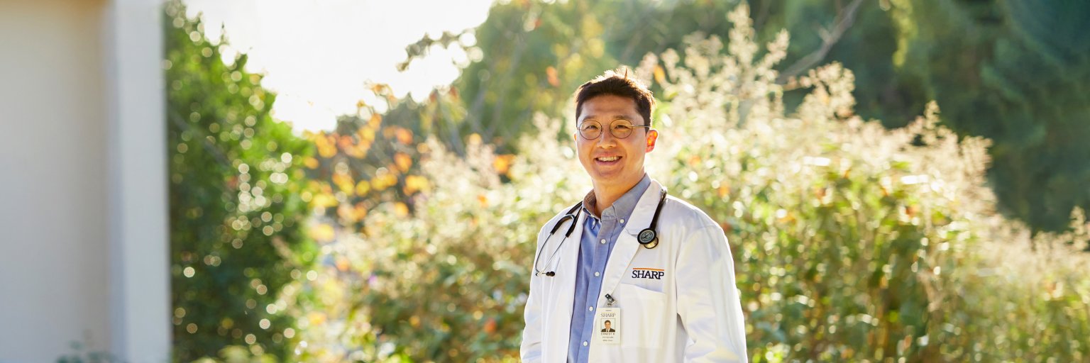 Dr. Kim smiling outside.