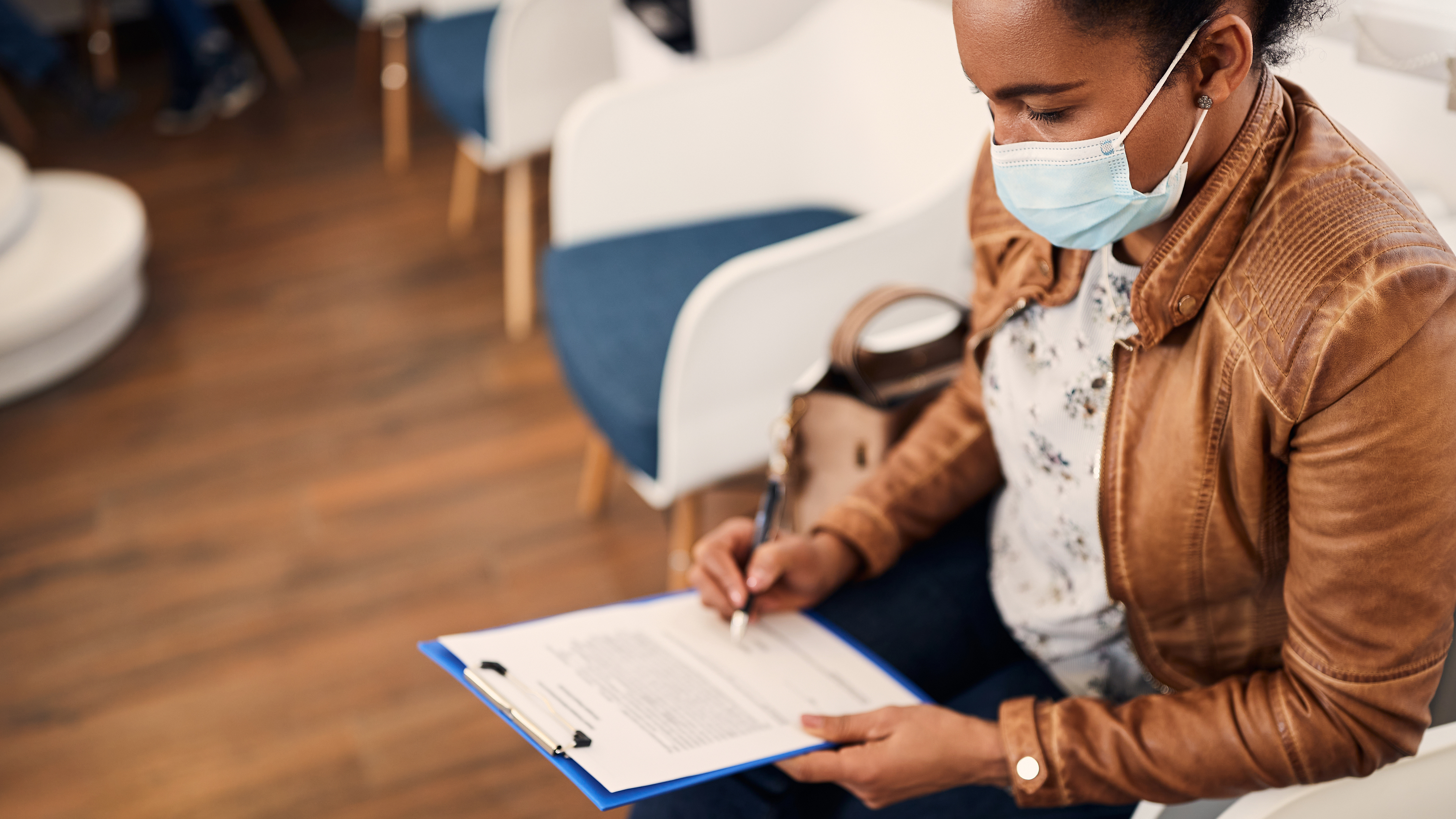 Woman filling out form in doctor's office