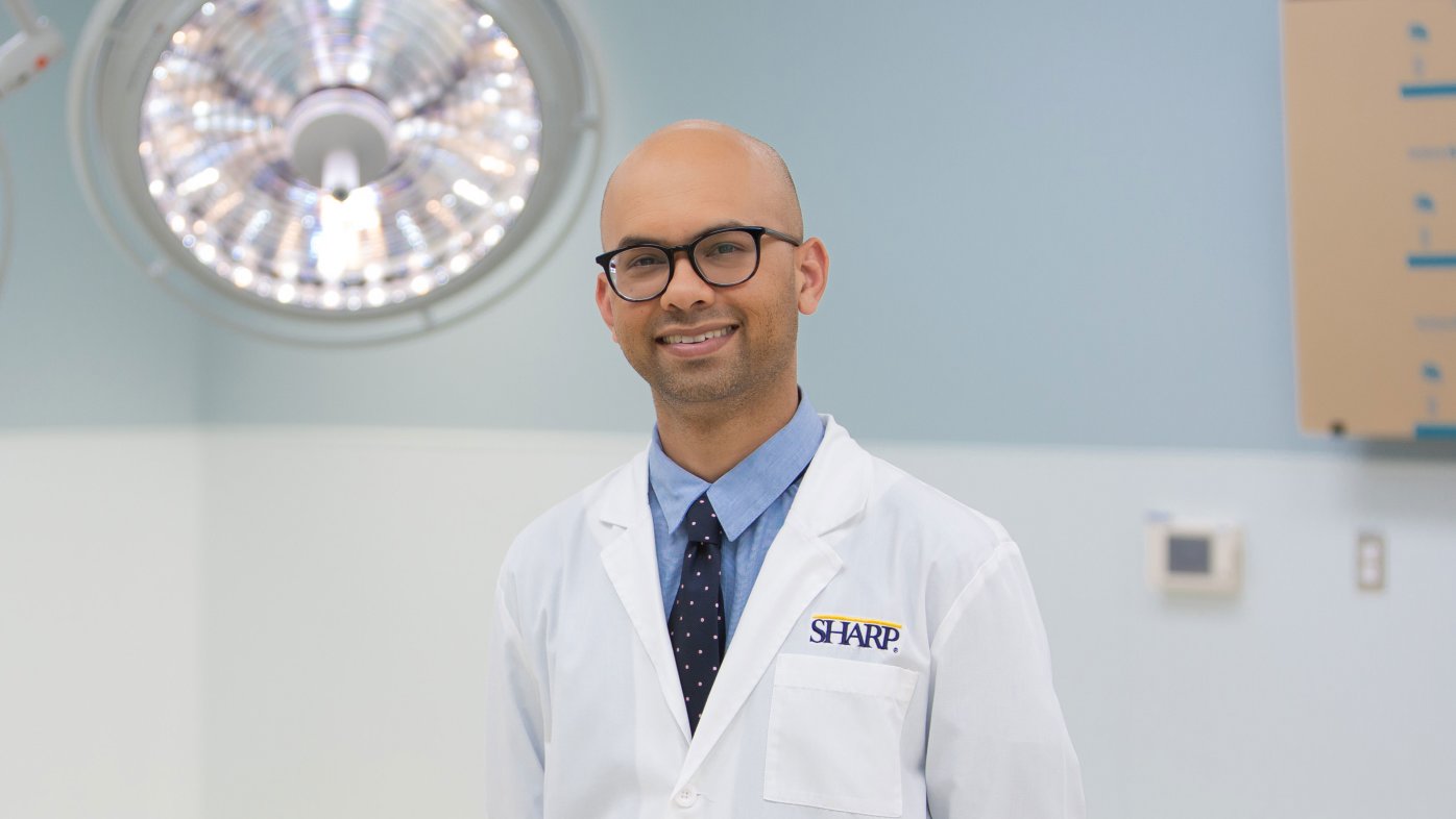 Portrait of Dr. Mehta in surgery room. 