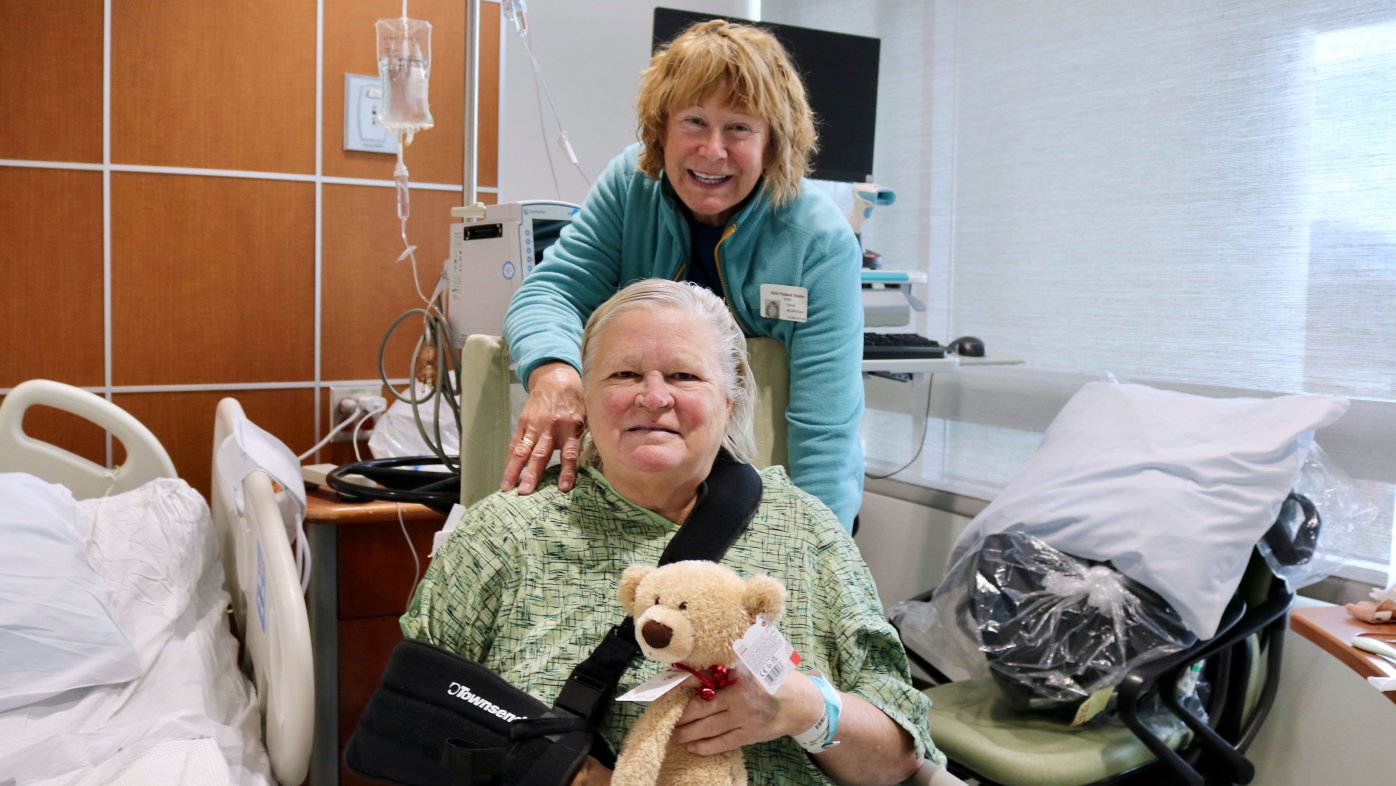 Joanne and Diane McGrogan posing with their bear at Sharp Grossmont Hospital