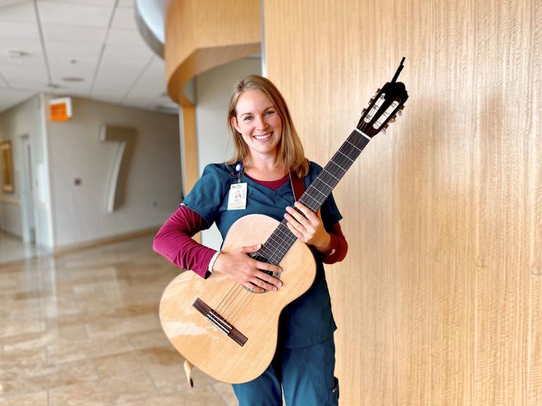 Amy Andrews, a music therapist with Sharp HealthCare's Arts for Healing program, with her guitar.