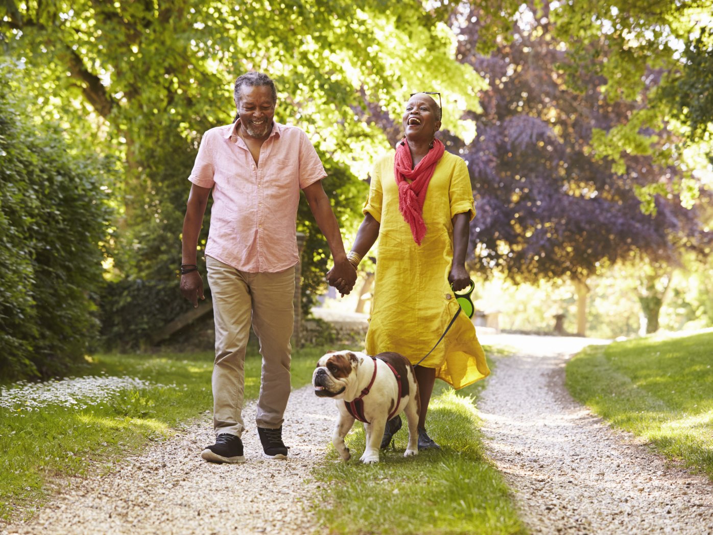 Senior couple walking with dog