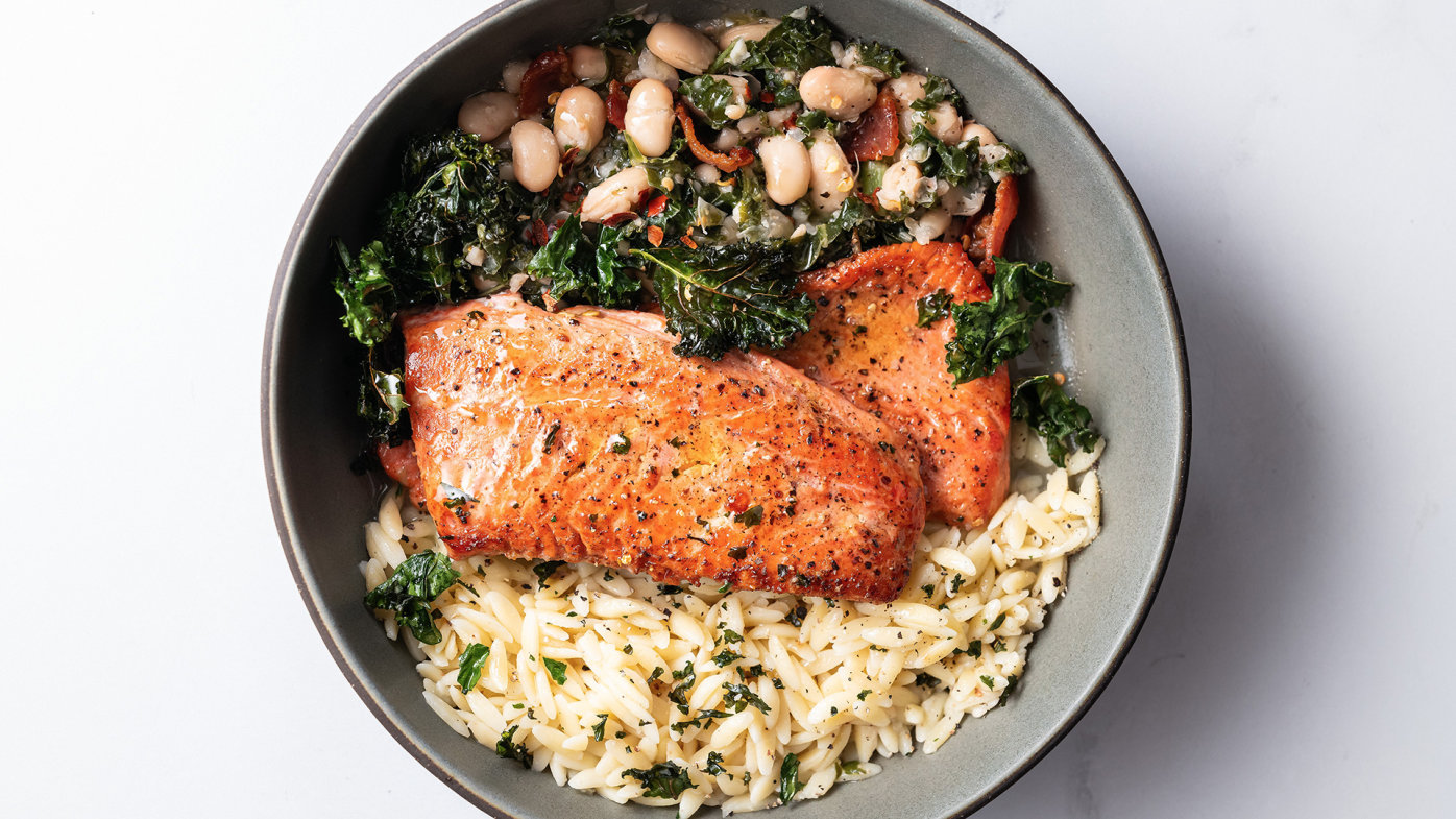 Salmon, rice and kale bean salad on a plate