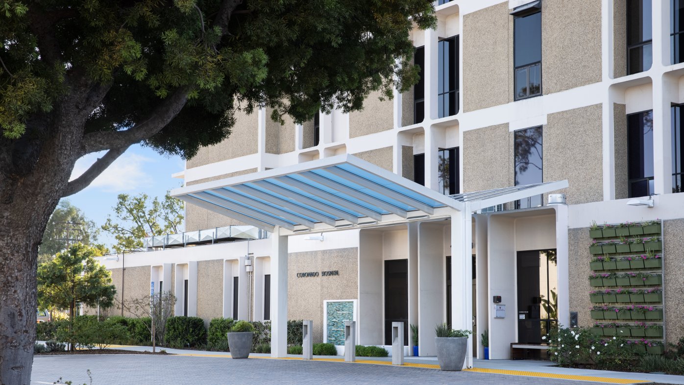 Exterior of Sharp Coronado Hospital with tree on left and entrance to lobby on right