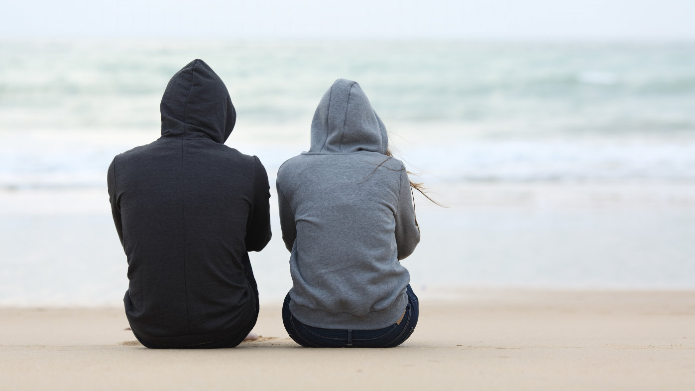Couple sitting together on the beach