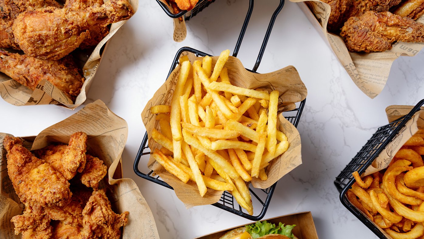 Bowls of fried foods such as French fries and fried chicken