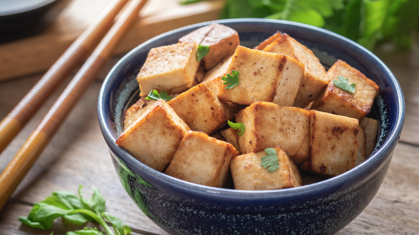 Bowl of cubed tofu with chopsticks