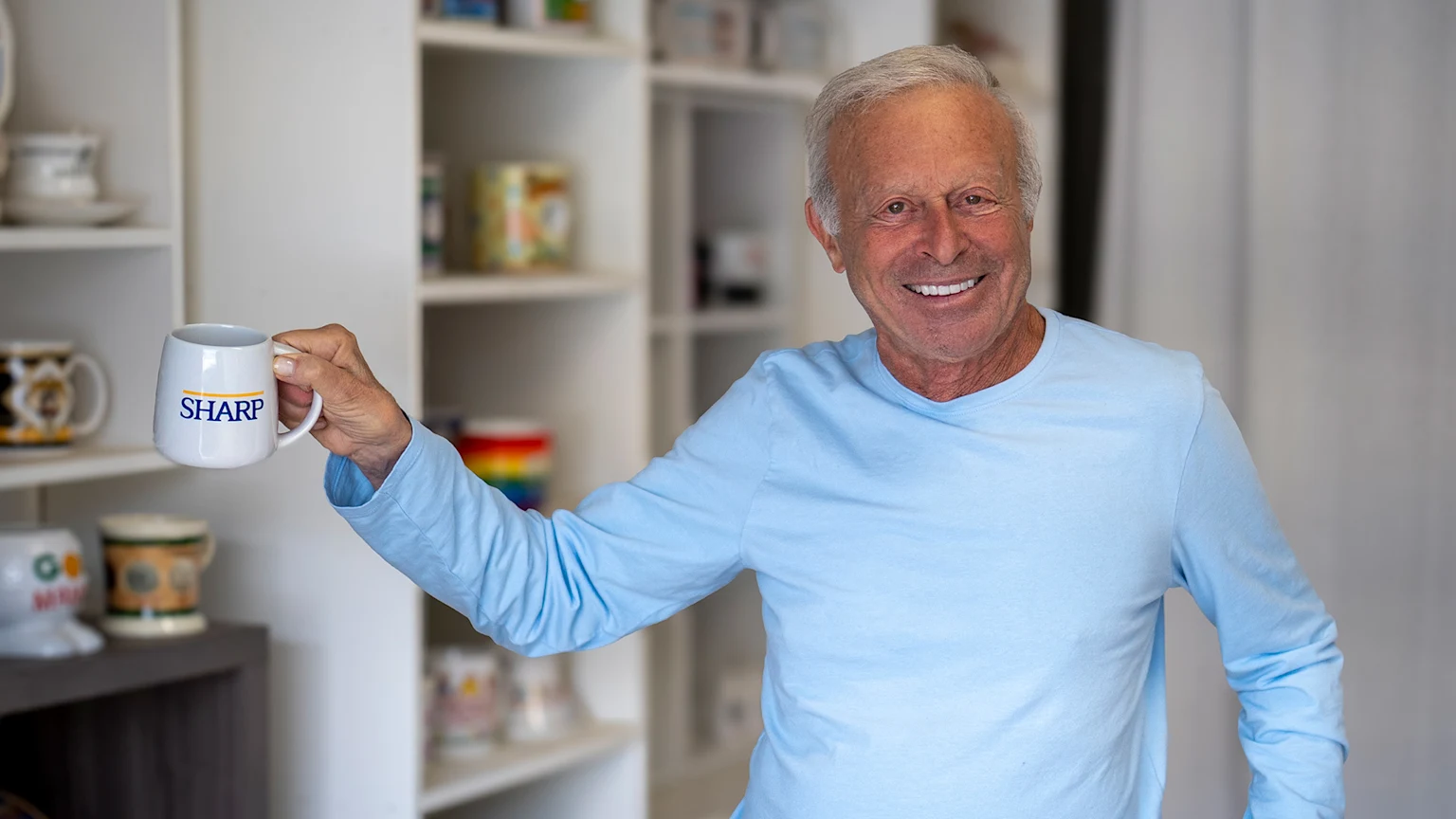 Stanley Papel of San Diego with a mug for Sharp HealthCare