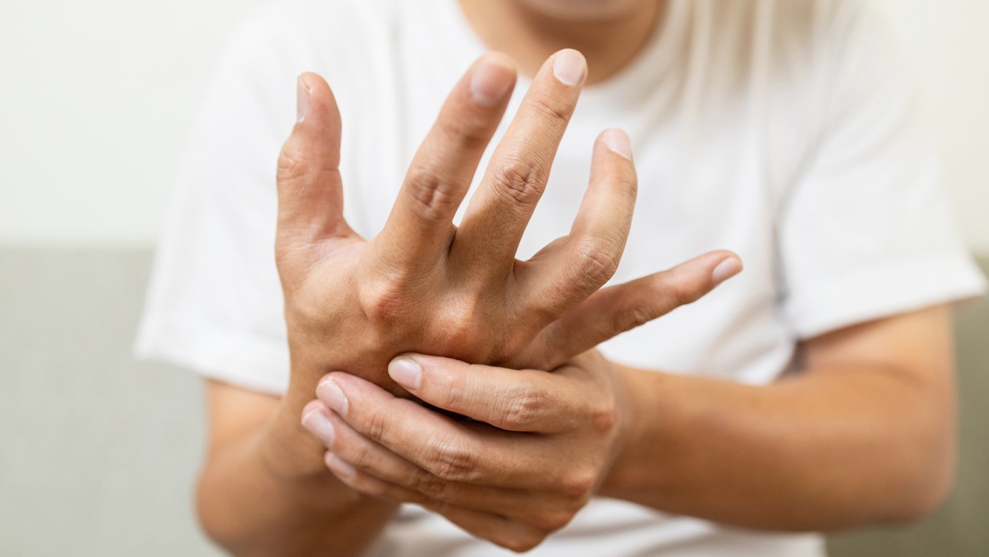 Person experiencing hand pain
