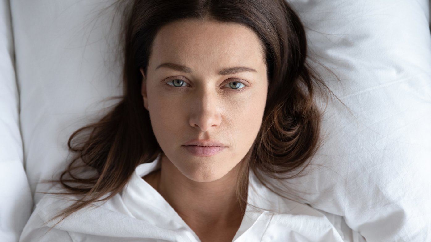 Woman lying awake in bed